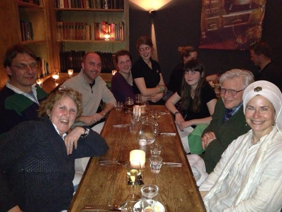 Democratic education advocates gathered around a candlelit wooden table in a room lined with bookshelves in Soest, the Netherlands.